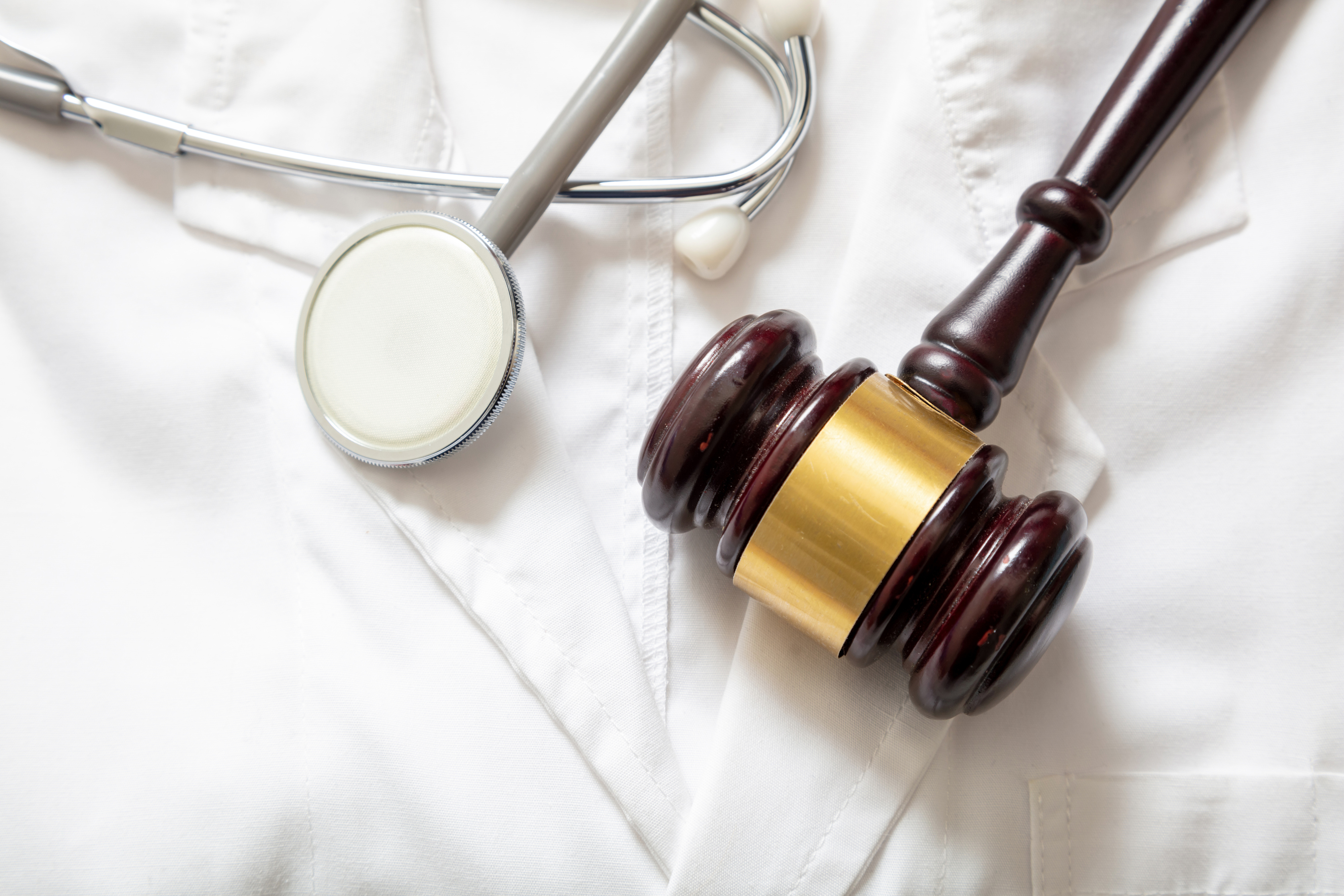Health and Law. Medical malpractice, personal injury lawyer. Judge gavel and doctor stethoscope
